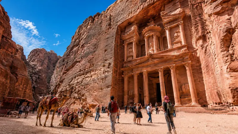The ancient treasury building carved into the pink stone cliffs of Petra, Jordan in a tour organized by Piccola Travel, a Miami travel agency.