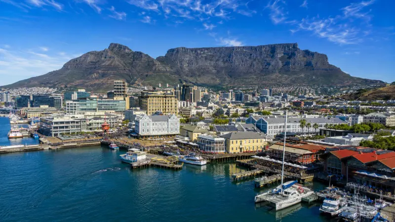 Scenic panoramic view of Table Mountain and the Victoria & Albert Waterfront in Cape Town, South Africa.