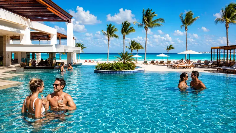Couples relaxing in the pool at a Cancún all-inclusive resort