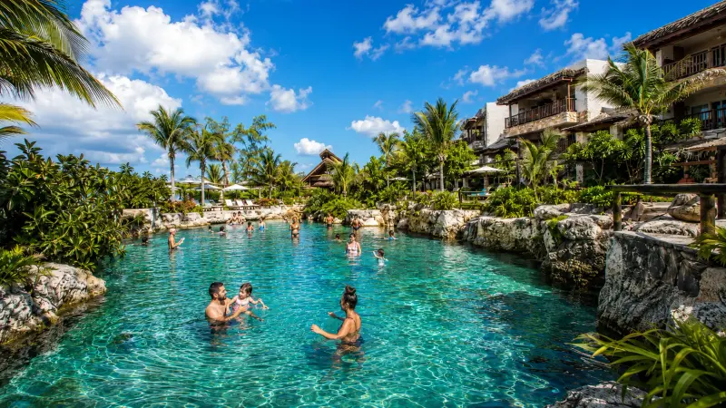Guests in a cenote-side plunge pool at a Riviera Maya resort