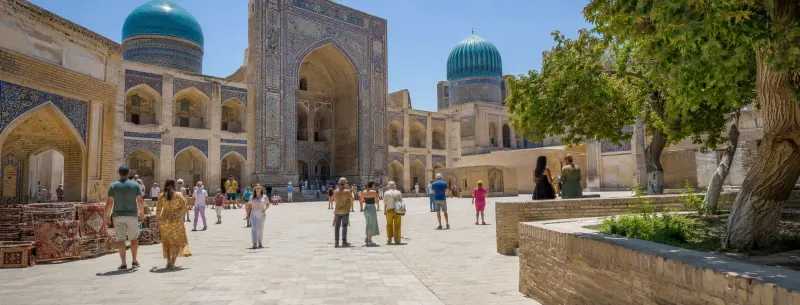 Uzbekistan Silk Road tour packages — Samarkand Registan Square and Bukhara blue domes planned by Piccola Travel, a Miami travel agency.