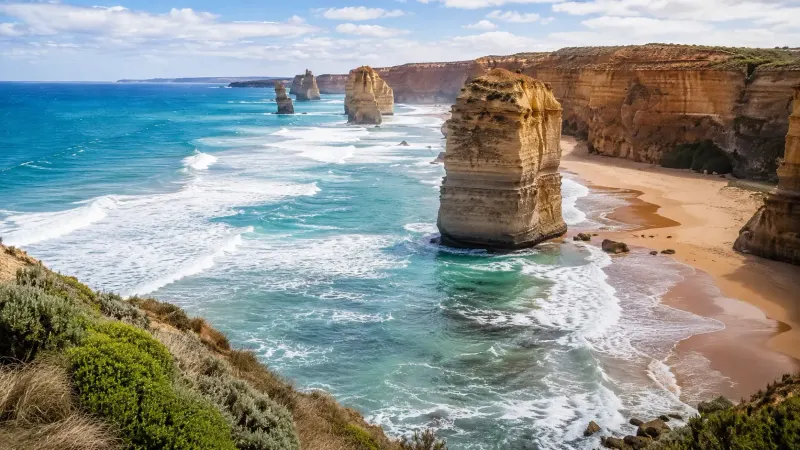 The dramatic limestone Twelve Apostles along the rugged coastline of the Great Ocean Road in Australia. Tour packages organized by Piccola Travel, travel agency in Miami.