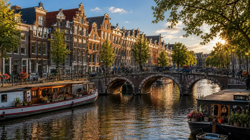 A canal, arched bridge and gabled houses in Amsterdam