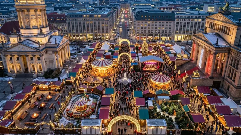 Illuminated Christmas market stalls on a European holiday markets tour
