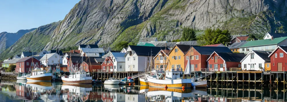 Red cabins in a Norwegian fishing village on a Scandinavia and northern lights tour