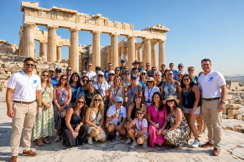 Corporate incentive group photographed together at the Acropolis in Athens during an incentive trip organized by Piccola Travel, a Miami travel agency.
