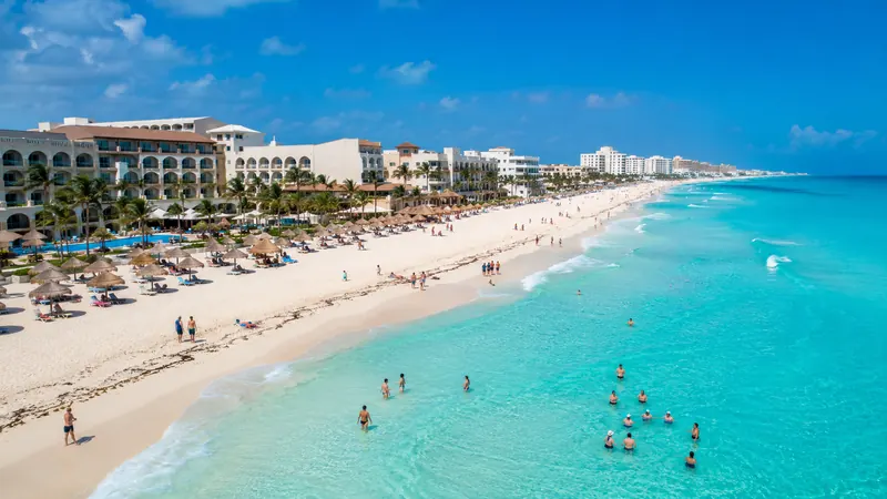 Aerial view of Cancun's Hotel Zone beach lined with resorts
