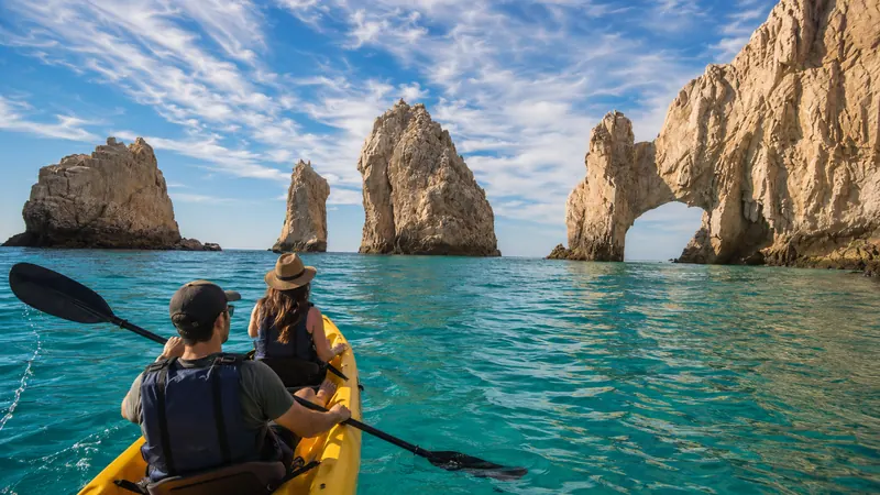 Couple kayaking toward the Arch of Cabo San Lucas