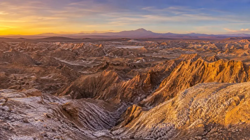 Sculpted desert formations of the Atacama's Moon Valley at sunset — Atacama Desert Chile tours.