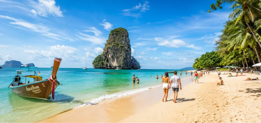 Piccola Travel Bali island vacation — couple relaxing on tropical beach from Miami.