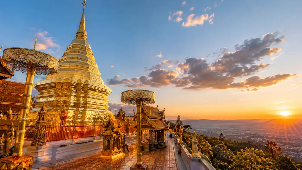 The golden chedi of Wat Phra That Doi Suthep glowing above the mountain panorama of Chiang Mai