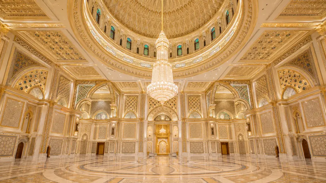 The golden dome hall inside the Qasr Al Watan presidential palace with its crystal chandelier and geometric detail