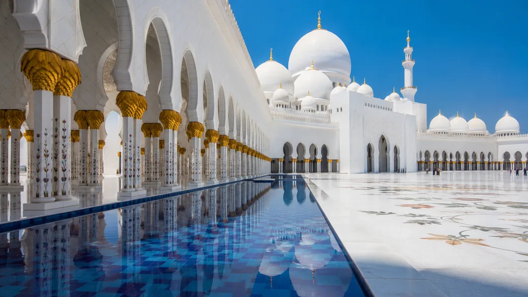 White marble columns and reflecting pools in the courtyard of the Sheikh Zayed Grand Mosque in Abu Dhabi