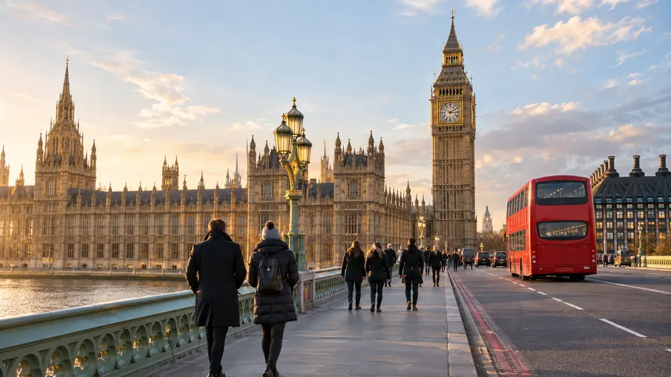 Westminster Bridge and the Houses of Parliament in low winter sun with a red bus crossing