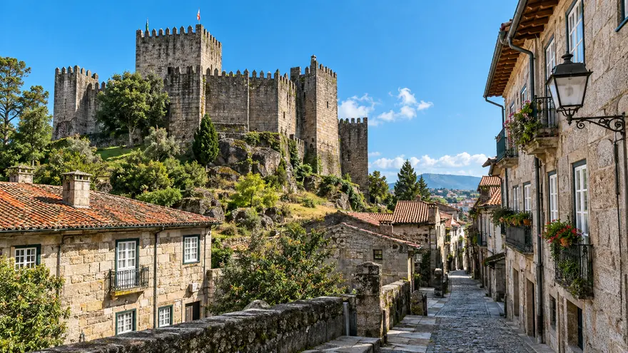 The medieval castle and stone streets of Guimaraes under a blue sky