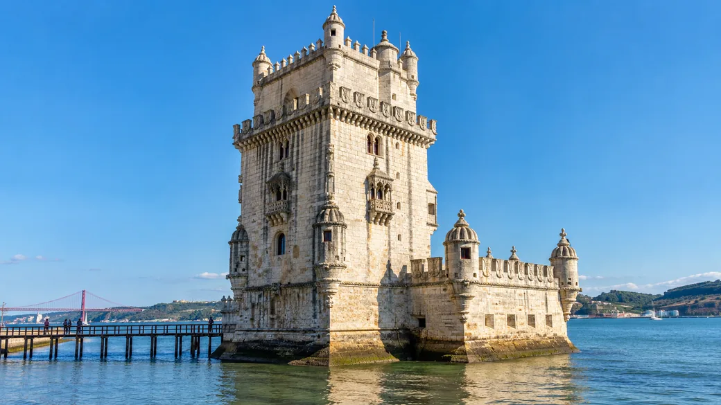 Belem Tower on the Tagus River in Lisbon under a bright blue sky