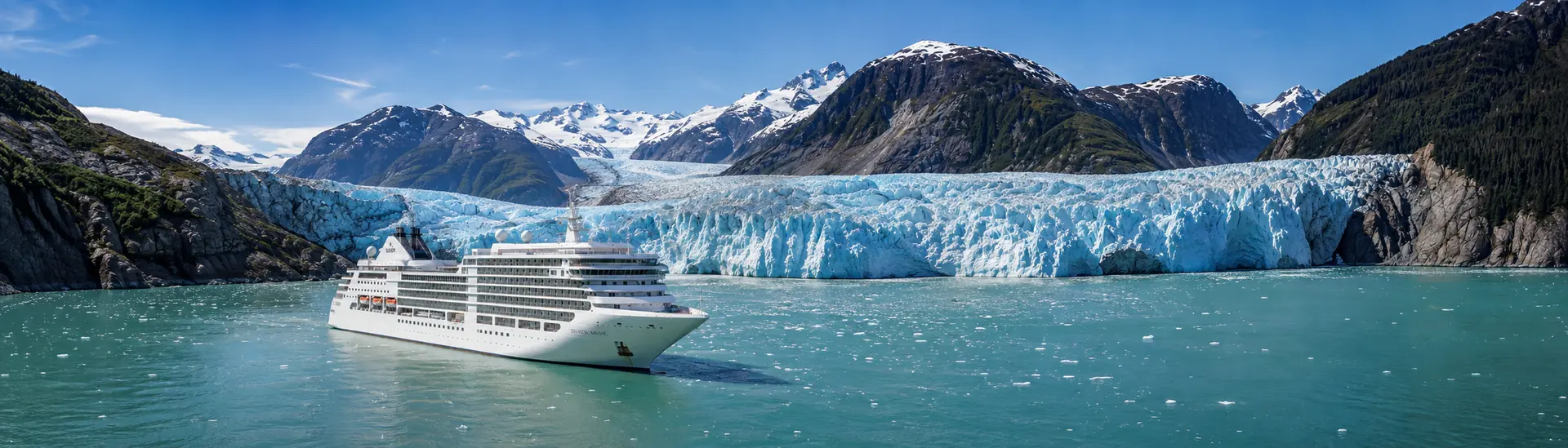 Cruise ship before a blue tidewater glacier on the Inside Passage — Alaska cruise packages.